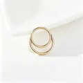 Detailed view of high-quality gold titanium steel double rings for ear or nose piercing - 1.2*8mm / Gold Color Round Style