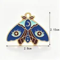 Detailed blue enamel moth jewelry charm with moon and star eye patterns, 2.8cm wide - Royal Blue Mystic Eye Moth