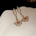 Elegant gold-tone fan-shaped drop earrings with shimmering crystals and peach center stone - Earring Only / Gold
