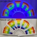 10-inch bamboo rainbow PRIDE folding fan showing UV light and natural light effects - PRIDE Rainbow Text UV Glow A73