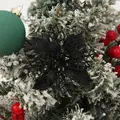 Macro detail of a 9cm black glitter hollow poinsettia flower on a snowy Christmas tree branch. - Black