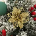Detailed view of a gold glitter hollow poinsettia flower decoration for Christmas tree. - Gold
