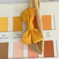 Handmade high elastic yellow bow headband for babies and infants with color swatch background - Dandelion Yellow