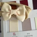 Cream-colored high-elastic baby headband with a handmade grosgrain ribbon bow. - Cream