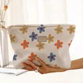 Close-up of hand-painted floral corduroy makeup bag with zipper closure and patterns - Blue Orange Yellow Floral with Label (KB48144)