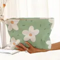 Detailed view of the corduroy fabric and floral print on a green zipper makeup bag - Green Large White Flower (MQ211344)
