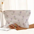 Close-up shot of a purple tulip floral printed corduroy zipper pouch held by hand - Purple Tulip (MN173195)