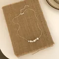Elegant silver necklace featuring alternating white pearls and crystal-studded spheres. - 3 Pearls 3 Rhinestone Balls (B-28)