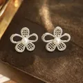Elegant silver-toned flower mesh stud earrings with a central white pearl detail. - No.7 White Flower Style