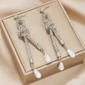 Elegant silver knot earrings with sparkling rhinestones and white drop pearls. - Bowknot Artificial Pearl (Silver)