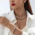 Professional model wearing a silver beaded necklace and bracelet jewelry set with earrings - 30349-NBR-S-set