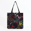Close-up detail of a vibrant botanical floral print on a large canvas tote shopping bag - Dark Background Multicolored Botanical Berry Print (hm5186)