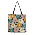 Detailed view of a large capacity floral print tote bag with vibrant flowers and black straps - White with Large Multicolored Flower Print (hm5194)