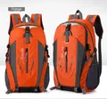 Front and side view of a large orange hiking backpack with multiple compartments. - Orange