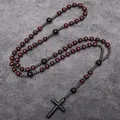 Detailed view of long religious rosary necklace with red wood beads and black cross pendant. - Red