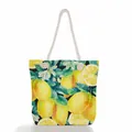 Front view of a canvas tote bag featuring a vibrant watercolor lemon and floral pattern. - Lemon and White Flowers (ms0648)