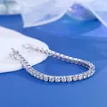 Elegant 925 silver tennis bracelet with round moissanite stones on a blue background. - 16.5cm (6.5 Inches) / 4mm Moissanite - White Gold