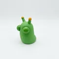 Close-up of a green pop-eye caterpillar stress relief toy isolated on a white background - Decompression Vegetable Worm