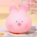 Detail of a cute pink squishy toy for stress relief with a minimalist rabbit face design. - Sakura Pig/Rabbit Stress Toy (6cm)