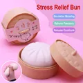 Detail view of realistic steamed bun squishy toy in a mini plastic steamer basket - Large Bun Stress Toy (with Steamer)