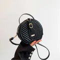 Elegant black quilted round crossbody bag with gold-tone hardware and top handle strap - Black