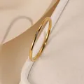 Minimalist stainless steel ring in gold finish with a small centered cubic zirconia - 10-c-8 Gold With One 1mm Diamond / Size 5