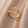 Close-up of gold olive branch ring with marquise zircons on elegant champagne silk - Gold Olive Branch Pave Style (JZ4388G)