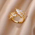 Macro view of elegant gold leaf open ring with marquise-cut clear zircons on satin - Gold Double Leaf Style (JZ4459G)