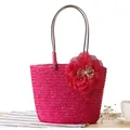 Vibrant pink hand-woven straw beach tote bag with decorative flower detail. - Rose Red