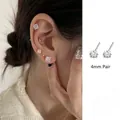 Detailed close-up of 4mm square cubic zirconia stud earrings with S925 silver needle - 4mm