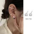 Close-up of 5mm S925 silver square cubic zirconia stud earrings for ear cartilage - 5mm