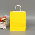 Elegant vibrant yellow paper gift bag with sturdy white twisted handles for retail shopping - Yellow; Extra Small Vertical Size (12*15*6)
