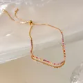 Elegant 18k gold plated adjustable bracelet featuring vibrant zircons on a reflective surface - Multicolor Zirconia (HB5996) / Gold