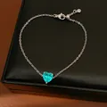 Close-up of a silver chain featuring a brilliant heart-shaped turquoise zircon pendant - Bracelet / Green