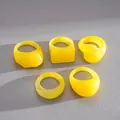 Macro view of five yellow resin geometric rings with square and round shapes - 5 Pieces / Yellow