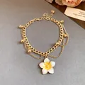 Detail of gold layered anklet featuring a white and yellow enamel flower pendant - Anklet-Gold-White