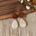 Macro detail of retro resin teardrop earrings with amber oval and marbled cream drop - Beige and Coffee