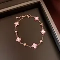 Elegant rose gold bracelet featuring pink zircon flowers and metallic beads in a box - Bracelet / Rose Gold-Pink