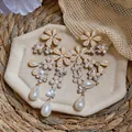 Detail view of French court style pearl earrings with crystal flowers and teardrop drops - Gold-White (925 Silver Needle)