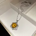 Macro detail of a star-shaped silver necklace with a brilliant yellow center stone. - Yellow