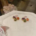 Bunte blumenförmige Zirkonia-Ohrstecker mit vier verschiedenen Blütenblattfarben und Vergoldung - bunt