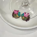 Close-up of vibrant butterfly floral stud earrings with colorful beads on a white plate - Butterfly Water Drop Flower Style (HE33260) / Silver Post-Pink-Green-Gray