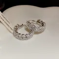 Detailed macro shot of vintage zircon wheat ear hoop earrings with a sparkling silver finish - Ear Buckle / Silver-White
