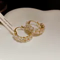 Elegant detail view of vintage gold hoop earrings with marquise zircon wheat patterns - Ear Buckle / Gold-White