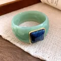 Detail shot of a chunky green acrylic bangle with a blue square resin inlay. - Light Green And Dark Blue