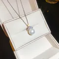Close-up detail of an elegant round pearl necklace with sparkling zircon accents - Silver