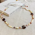 Macro view of ethnic beaded waist chain featuring colorful resin beads and cotton rope - Style 2