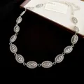 Detail view of a vintage silver ethnic style waist chain featuring oval relief links - Style 15