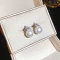 Detailed view of elegant silver needle zircon and round pearl stud earrings in a box - Silver-White