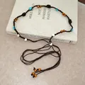 Close-up detail of bohemian beaded waist chain featuring turquoise and wooden beads on cord - Style 7